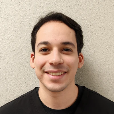 Chiropractor Noah Salinas Smiles Warmly at the viewer welcoming patients